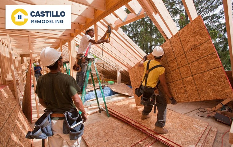 Construction workers installing framing and insulation in a new home.